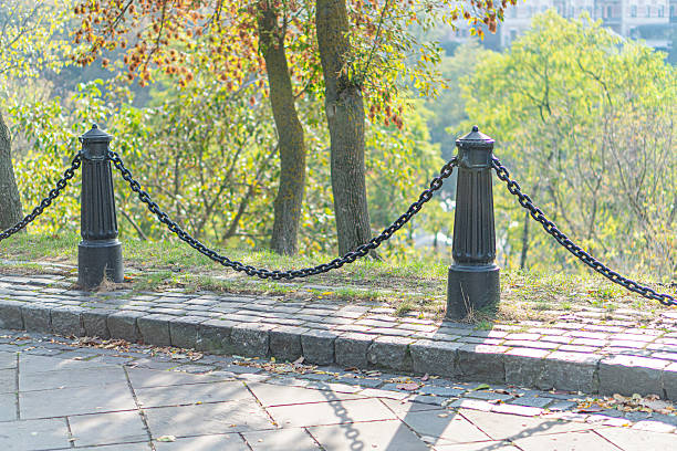 istock A charming, inviting scene featuring a cobblestone path leading to a tranquil lake in a well-maintained park The perspective enhances depth, while warm colors and soft light add to the serene ambian 2211348342