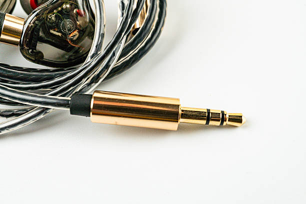 istock A high-quality gold-plated audio cable with a 35mm jack connector, coiled and extended, showcased against a white background for a luxurious contrast The cable is practical yet aesthetically pleasi 2211348355