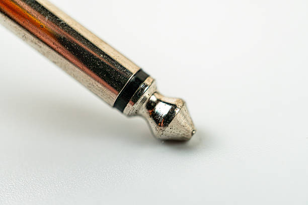 istock Close-up of a dark brown ink pen on pristine white surface, suggesting creativity and precision 2211348551