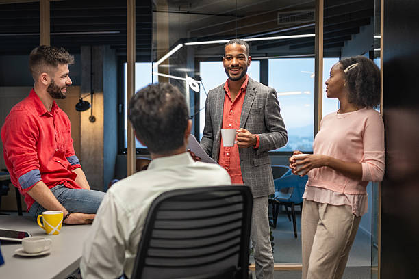 istock Diverse Business Professionals Enjoying Coffee Break in Bright Modern Office Setting 2211349333