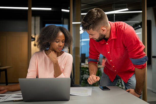 istock Focused Business Collaboration Between Colleagues in Modern Office Setting 2211349347