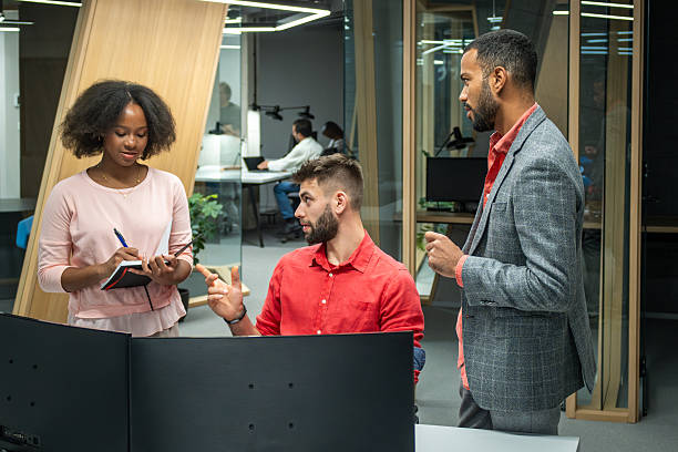 istock Diverse Business Executives Collaborating in Modern Office with Bright Lighting 2211349364