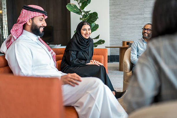 istock Smiling Arabic Business Team Discusses Strategy in Hotel Lobby 2211350227
