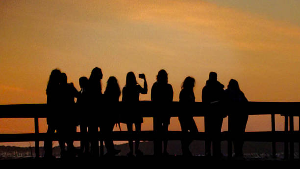 istock Crowd at waterfront boardwalk at sunset time, punta del este, uruguay 2211352379