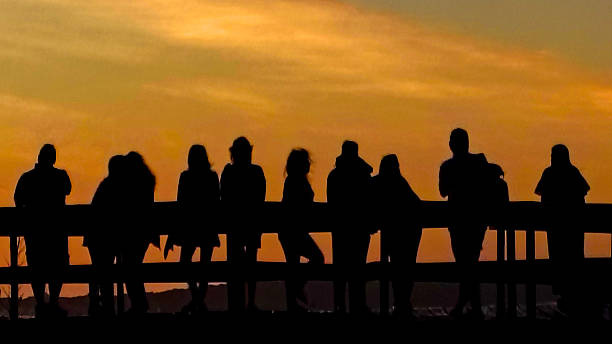 istock Crowd at waterfront boardwalk at sunset time, punta del este, uruguay 2211352381