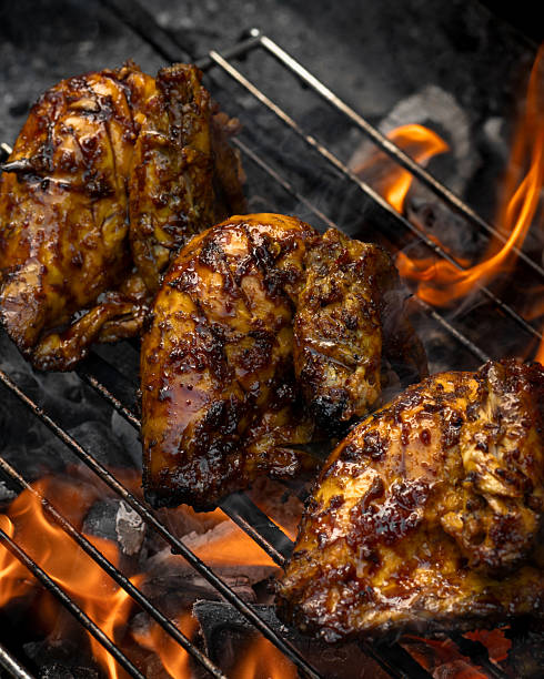 istock Three pieces of chicken are on a grill 2211357365