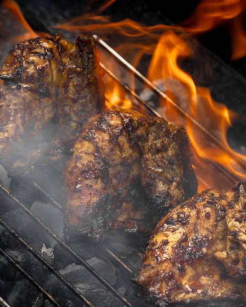 istock Three pieces of chicken are being cooked on a grill 2211357370