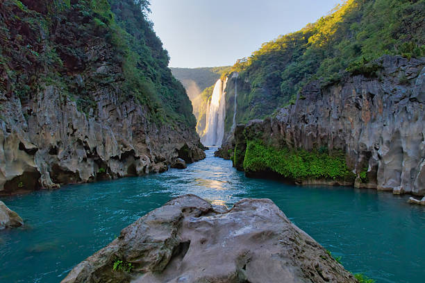 istock Tamul waterfall cascading into a turquoise river in mexico 2211357948