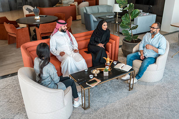 istock Engaged Arabic Businesspeople Discuss Strategy in Hotel Lobby 2211358131