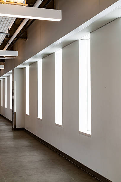 istock Modern Corridor with Geometric Window Design and Neutral Interior Lighting 2211358646