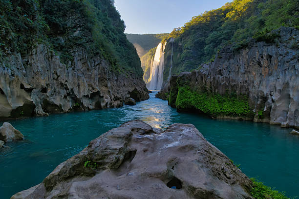 istock Tamul waterfall cascading into a turquoise river in mexico 2211359452