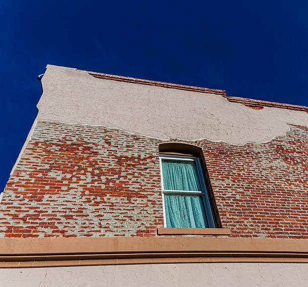 Lace Curtains on Windows and Brick Wall on Main Street, Williams, Arizona, USA