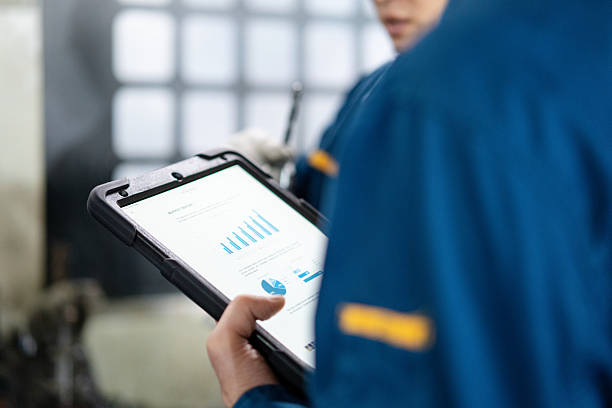 istock An Asian male worker is working in the factory workshop while holding a tablet computer with data analysis reports. 2211363179