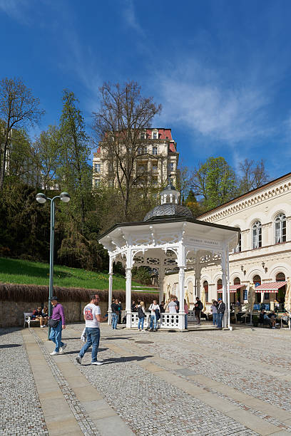 Karlovy Vary, Czech Republic – April 20, 2025: Tourists from all over the world at Pramen Svoboda, one of the many healing springs in the spa town of Karlovy Vary in the Czech Republic