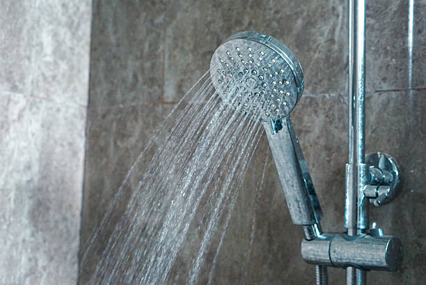 istock Water flowing from a shower head. 2211365990