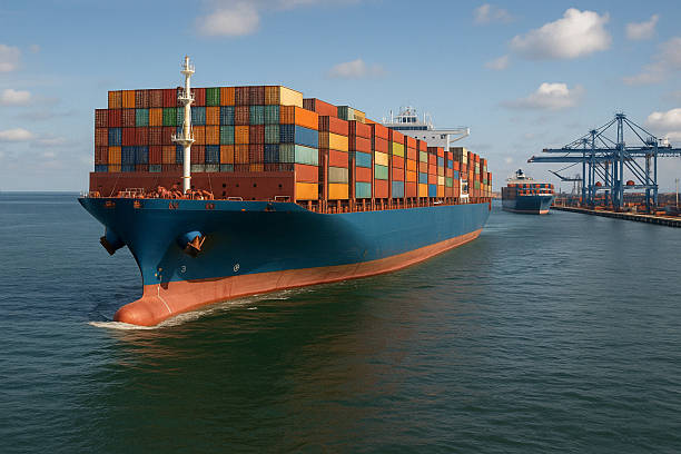 istock Container ship at cargo port with cranes and freight trucks 2211368736