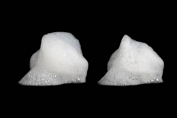 istock White liquid soap bubbles from soap, shampoo or shower gel isolated on black background. 2211372682