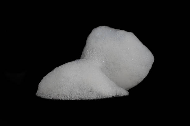 istock White soap foam, shampoo foam with bubbles, cream soap bubbles, isolated on black background. 2211372687