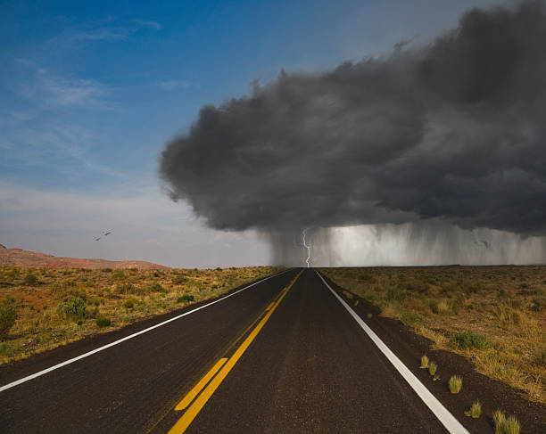 Highway leading towards storm cloud, Arizona