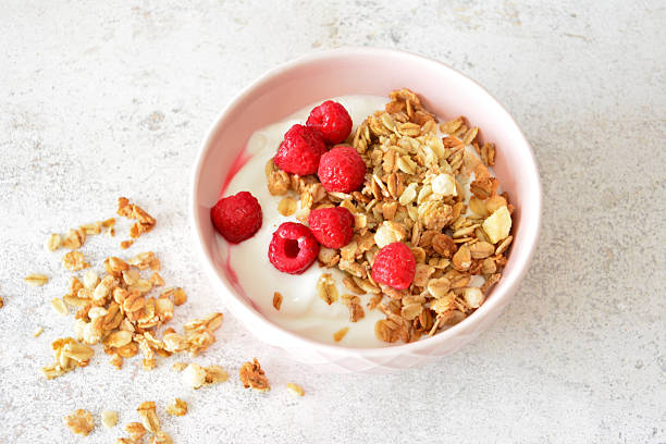 istock a pink bowl with muesli, yogurt and strawberry flat lay 2211378884