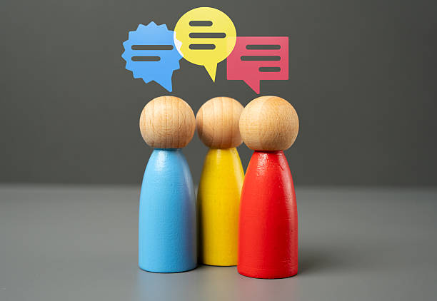 istock Three figures of people in active discussion and communication. Teamwork and brainstorming. Negotiations, collaboration, business meetings, social interactions, networking and debate 2211379127