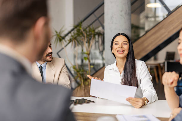 istock A businesswoman with paperwork in hands discussing and analyzing data at boardroom with her team. 2211379289