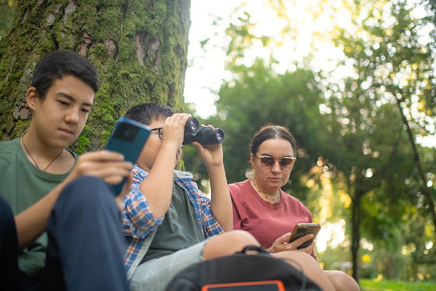 istock Family with smartphone and binoculars, bird watching 2211380066