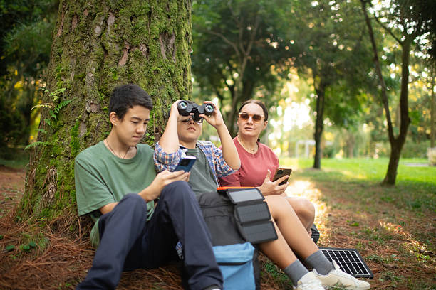 istock Family with smartphone and binoculars, bird watching 2211380097