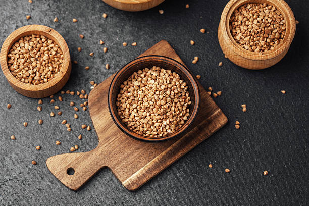 istock Sesame seeds arranged in wooden containers on a dark surface 2211380140