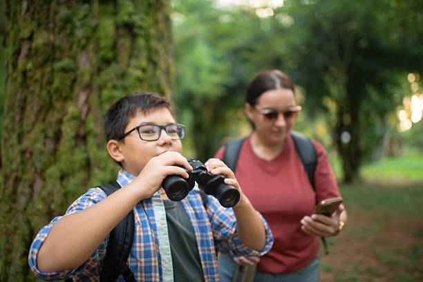istock Family with smartphone and binoculars, bird watching 2211380153