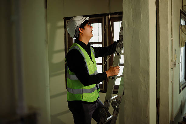 istock Site inspector climbing ladder for ceiling inspection in renovation site 2211381591