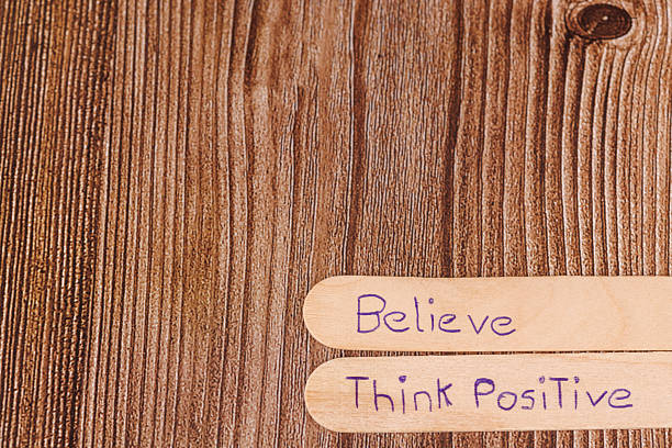 Inspirational wooden sticks reading “dream,” “imagine,” and more displayed on a wooden surface.