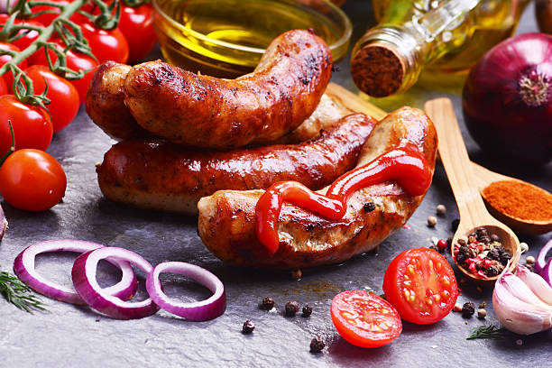 istock Pork sausages with spices and vegetables 2211383166