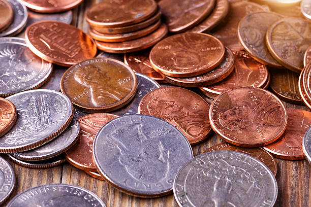 istock American coins and US dollars on a wooden table 2211383170