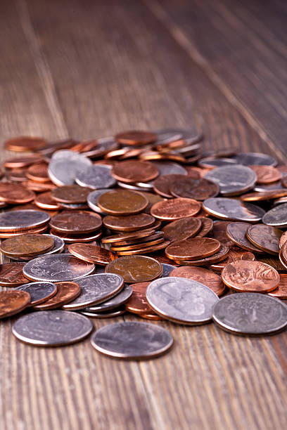 istock American coins and US dollars on a wooden table 2211383171