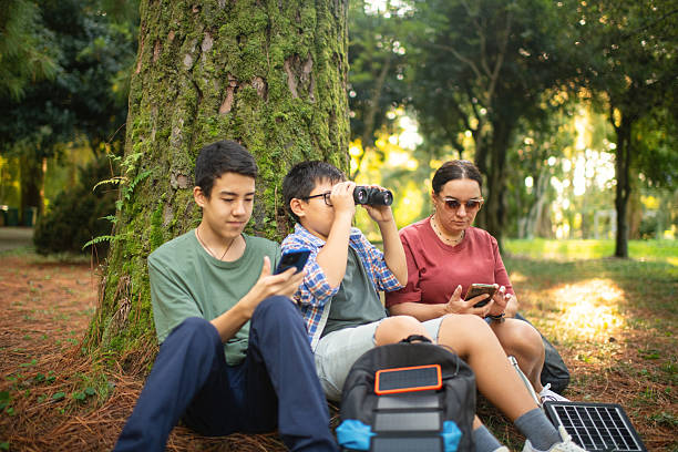 istock Family with smartphone and binoculars, bird watching 2211383675