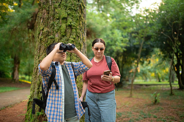 istock Family with smartphone and binoculars, bird watching 2211383976