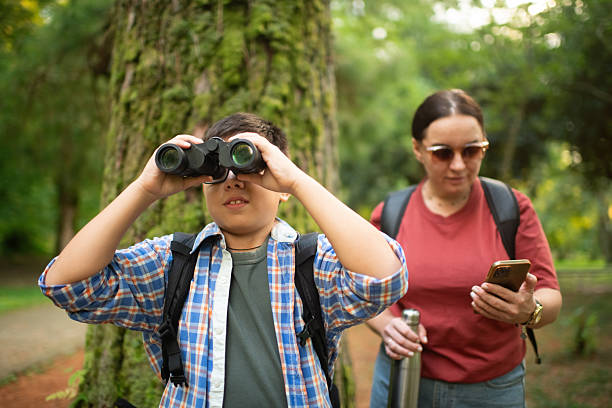 istock Family with smartphone and binoculars, bird watching 2211384035