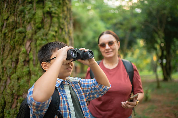 istock Family with smartphone and binoculars, bird watching 2211384058