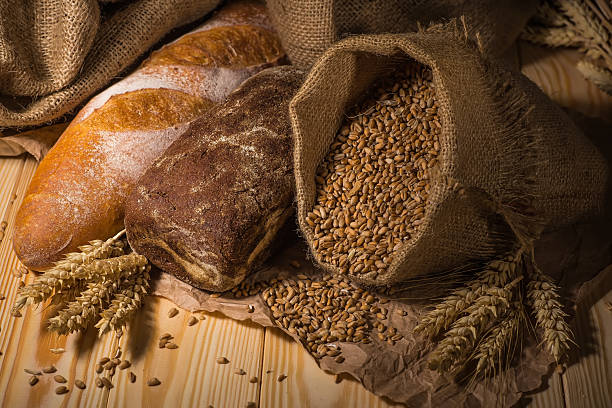 istock Assortment of baked bread on wooden table background 2211384281