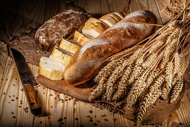 istock Assortment of baked bread on wooden table background 2211384310