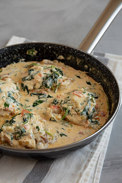 istock Homemade Creamy Tuscan Chicken with Spinach in a Pan, side view. 2211385206