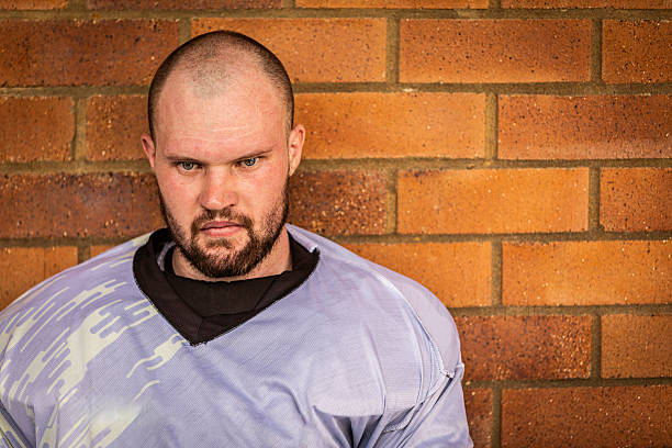 Football player sits on the bench exhausted
