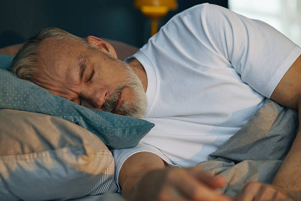 istock Elderly Man Sleeping Peacefully in Bed During Morning 2211389240