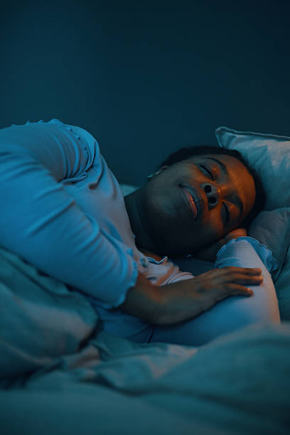 istock Sleeping African American Woman on Comfortable Bed 2211389324