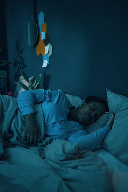 istock Sleeping Woman in Comfortable Room During Nighttime 2211389326
