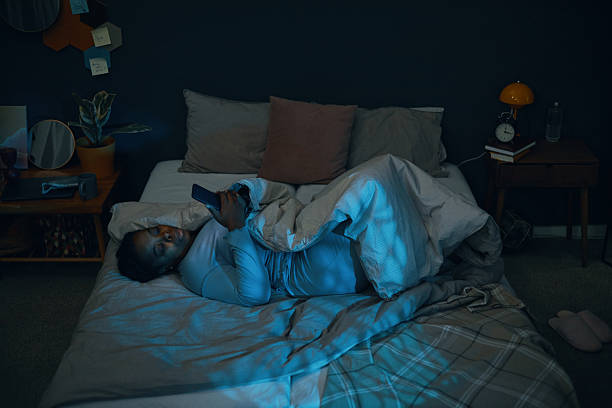 Relaxing on Bed with Smartphone in Cozy Ambiance