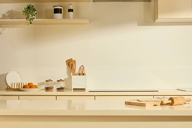 istock The kitchen with a luxurious marble dining table. The beige cabinets hold kitchen utensils. A wooden cutting board and rolling pin are placed on the table, other items are placed on the counter. 2211390401