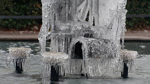 istock Frozen Water Fountain Covered in Icicles Amid a Wintery Setting 2211390980