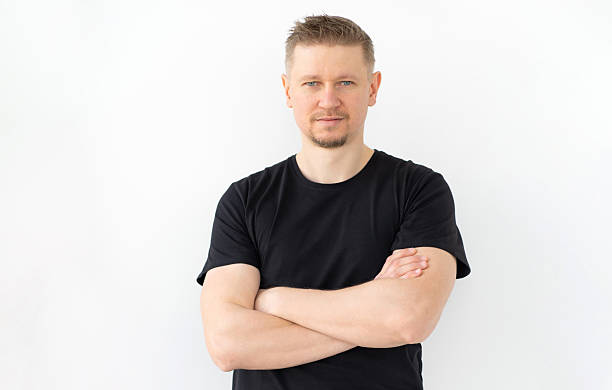 istock Handsome Man In Black T-Shirt With Hands Crosse 2211393321